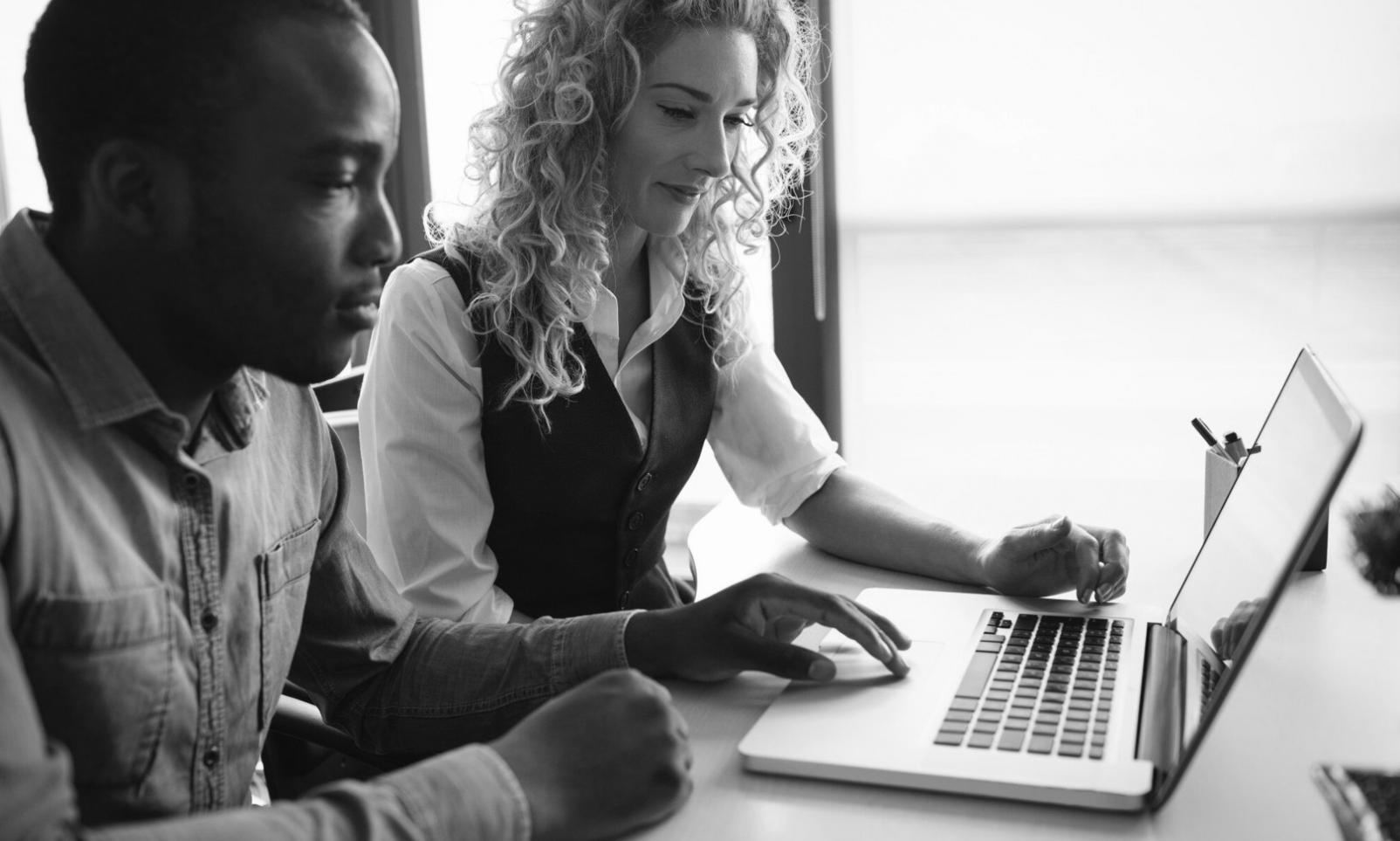 Family discussing monthly expenses together at kitchen table